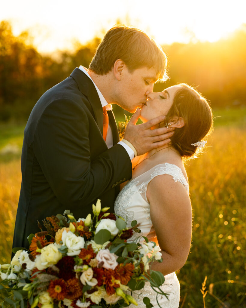 a beautiful fall wedding portrait showing the couple sharing a kiss