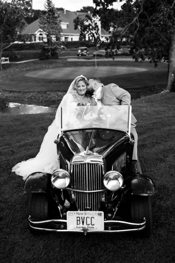 A timeless black and white wedding photo of the newlyweds, captured in a classic pose that exudes elegance and romance. The image showcases the couple in crisp detail, with the groom in a sharp suit and the bride in a stunning gown. The editing style of the photo gives it a timeless quality, ensuring that it will remain beautiful and relevant for generations to come.