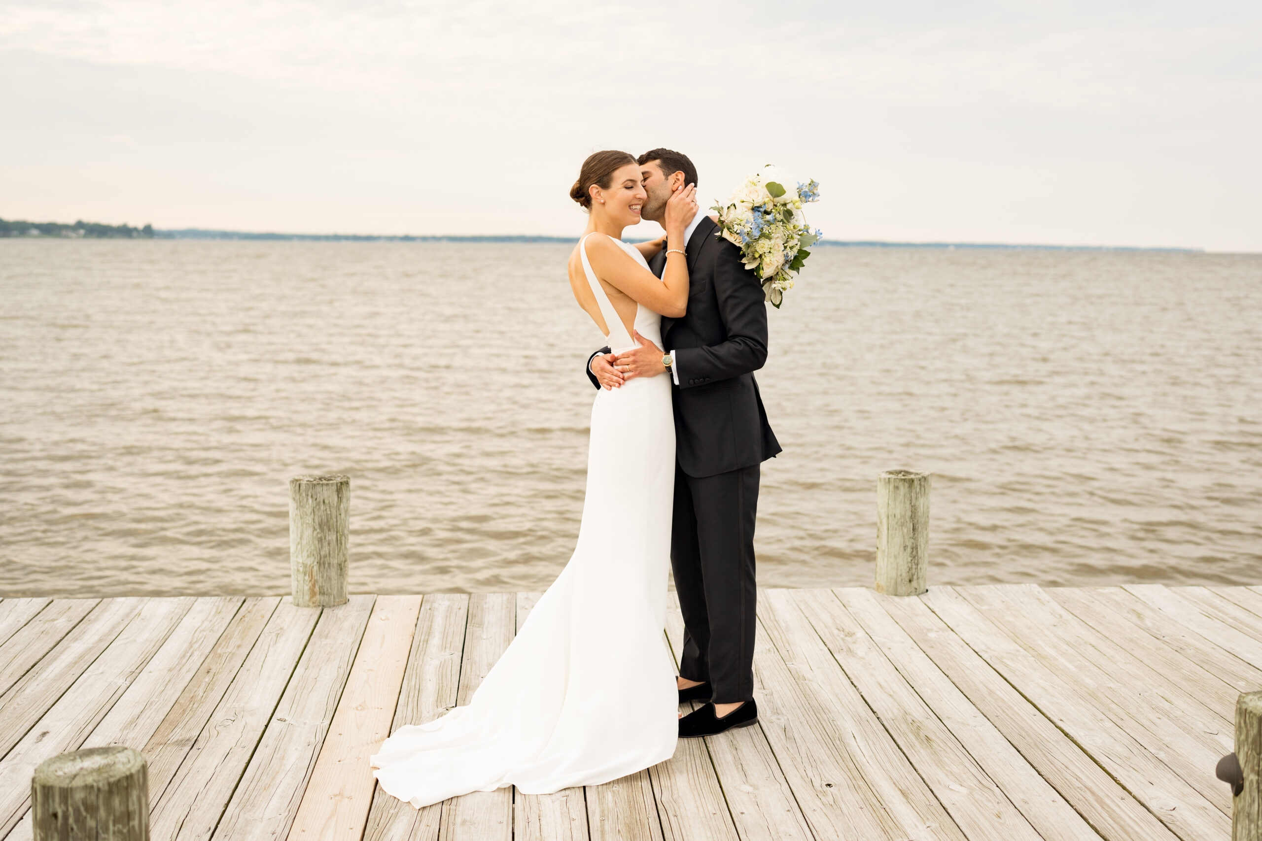 Emma and Fady had their traditional wedding ceremony and reception at the Polynesian Lawn and Paradise Ballroom at Herrington on the Bay. Herrington is a coastal wedding venue on Chesapeake Bay. These photos show the happy couple on the dock at the venue.