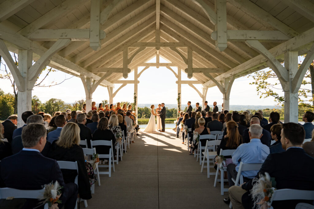 Bride and groom exchange vows in a beautiful ceremony captured by their wedding photographer. Essential questions to help you find the perfect photographer for your special day.
