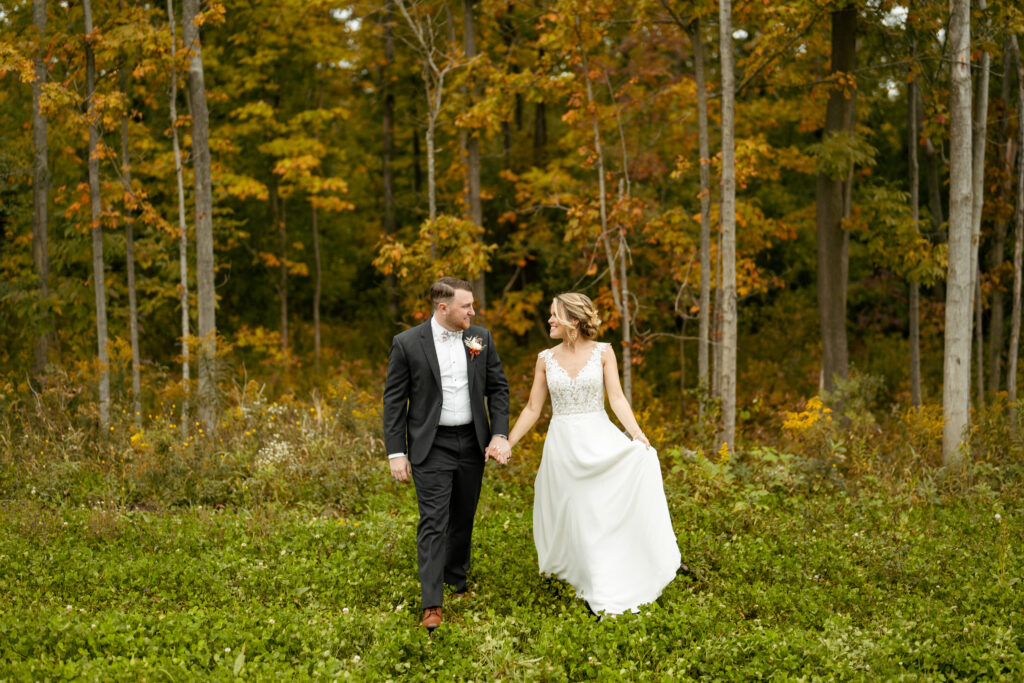 A stunning display of autumn colors in Upstate NY, with vibrant orange, yellow, and red leaves filling the frame against a forest backdrop. This image shows why timeless wedding photos will stand the test of time. 