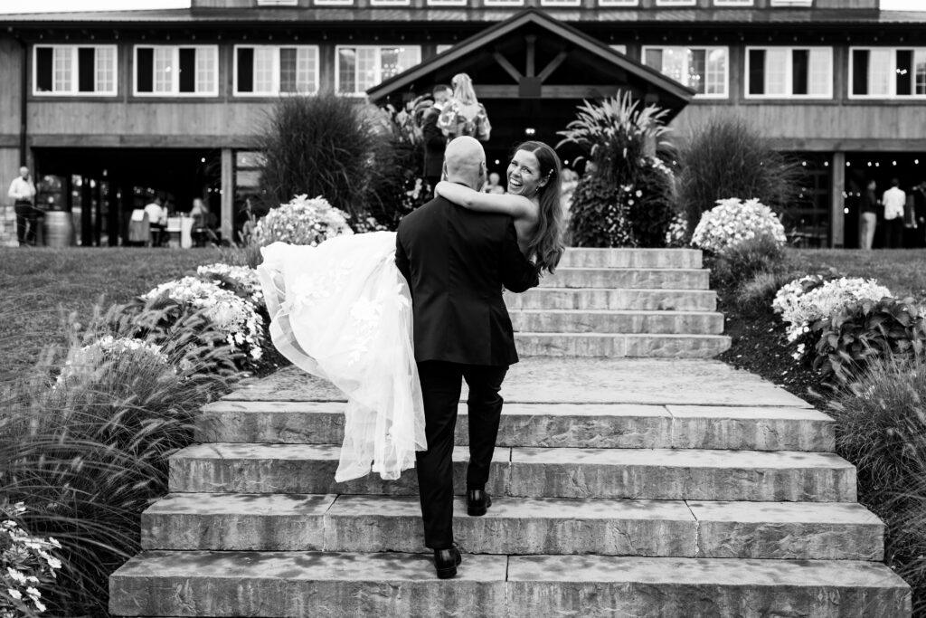 A timeless black and white wedding photo of the newlyweds, captured in a classic pose that exudes elegance and romance. The image showcases the couple in crisp detail, with the groom in a sharp suit and the bride in a stunning gown. The editing style of the photo gives it a timeless quality, ensuring that it will remain beautiful and relevant for generations to come.